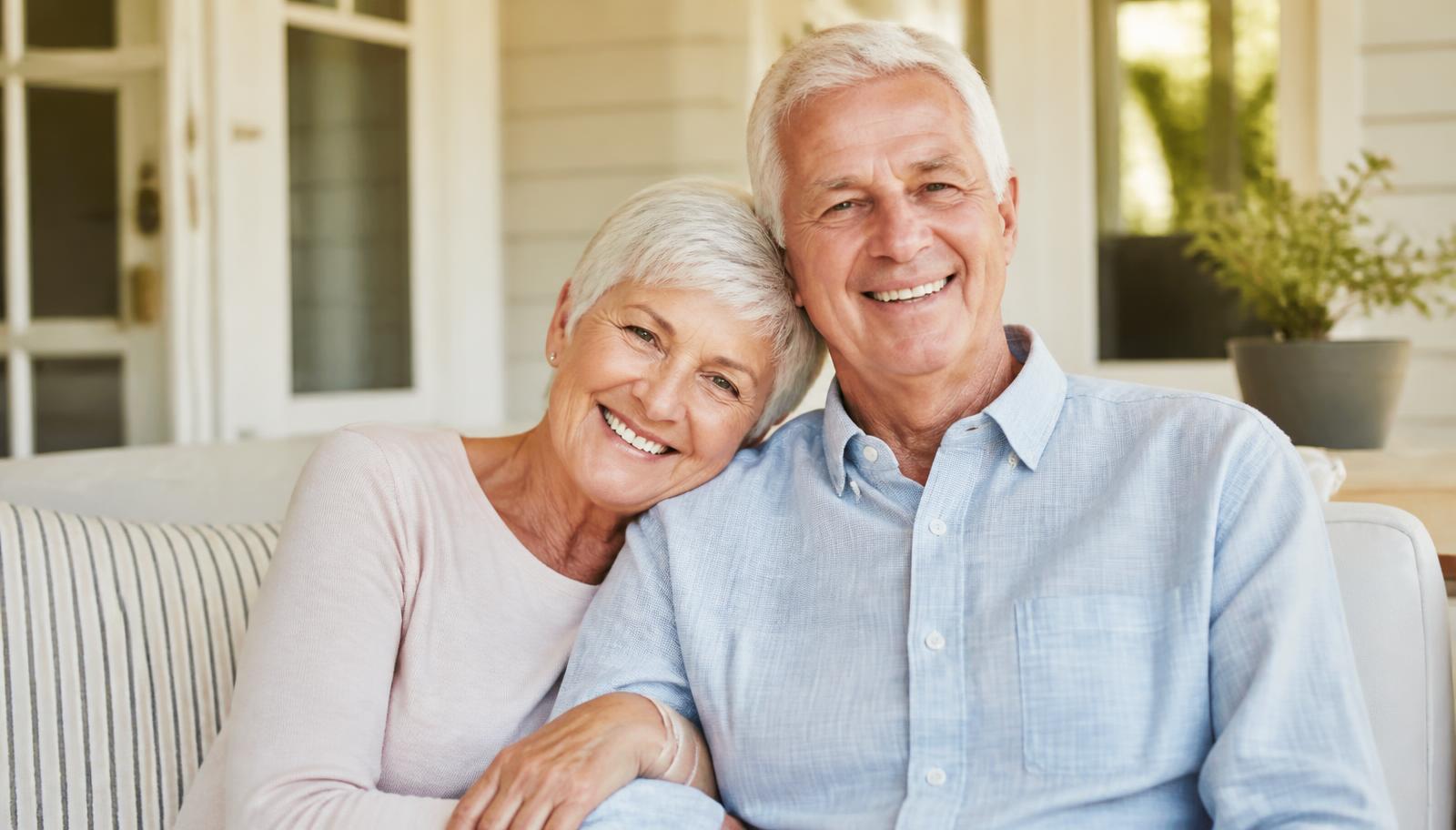 Smiling senior couple, relaxed about their health coverage